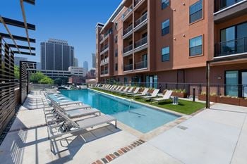 Resort-style swimming pool with outdoor lounging