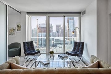 San Francisco apartment for rent - a living room with a large window and a couch and chairs