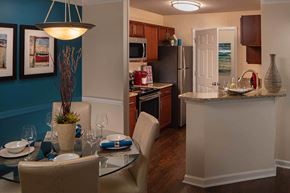 Alpharetta apartment for rent - Kitchen with stainless steel appliances, bar area and wood style flooring