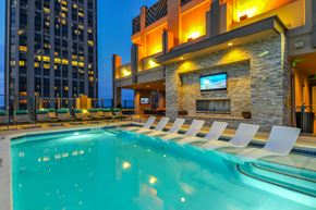 Atlanta apartment for rent - a swimming pool with lounge chairs in front of a building