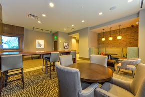 Atlanta apartment for rent - a dining area with a table and chairs and a bar