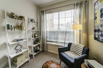 Durham apartment for rent - a living room with a large window and a couch and a chair