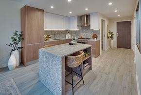 Chicago apartment for rent - a kitchen with a large island and wooden cabinets