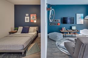 Chicago apartment for rent - a bedroom and a living room with a bed and a bike on the wall