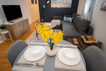 New York apartment for rent - a living room with a dining table with yellow flowers
