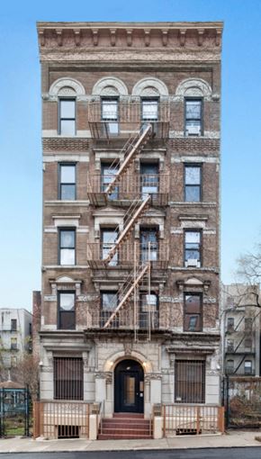 New York apartment for rent - the facade of a building with a fire escape
