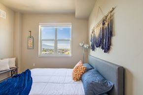 Salt Lake City apartment for rent - a small bedroom with a bed and a window