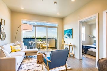 Salt Lake City apartment for rent - a living room with a couch and a chair and a balcony