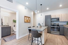 Salt Lake City apartment for rent - an open kitchen with an island and stools in front of a kitchen counter top