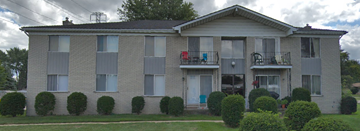 Shelby Twp apartment for rent - a white brick house with a porch and a yard