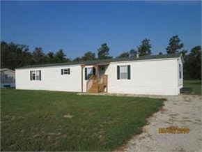 Aiken house for rent - A white mobile home with a brown door and windows.