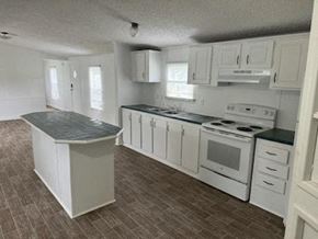 Aiken house for rent - A kitchen with white appliances and cabinets.