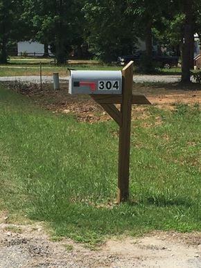 Greenwood house for rent - A mailbox with the number 304 on it is mounted on a wooden post.