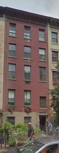 New York apartment for rent - a man riding a bike in front of a building