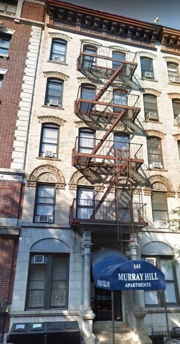 New York apartment for rent - a building with a fire escape on the side of it