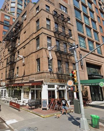New York apartment for rent - a person walking a dog in front of a tall building