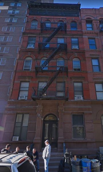 New York apartment for rent - a tall building with a fire escape on the side of it