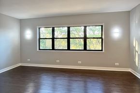 Oak Park apartment for rent - A room with a large window and wooden flooring.