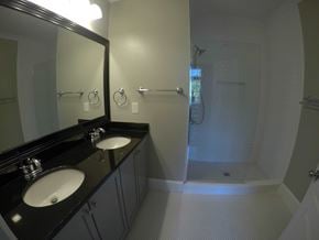 Atlanta house for rent - a bathroom with two sinks and a shower and a mirror