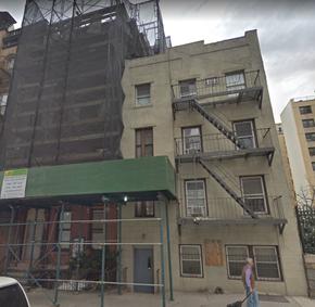 New York apartment for rent - a building with scaffolding on it and a man walking