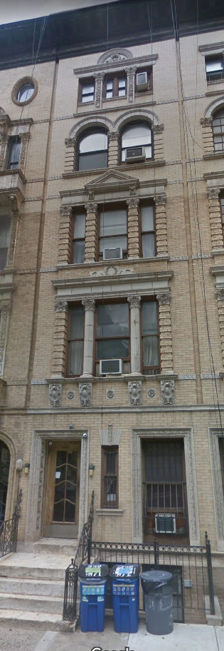 New York apartment for rent - the front of a building with trash cans in front of it