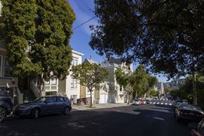 San Francisco apartment for rent - A street view with cars and trees.