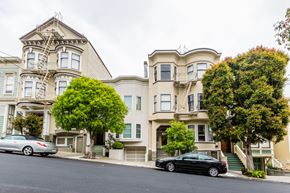 San Francisco apartment for rent - A black car is parked in front of a two-story house.