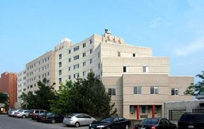 Ithaca apartment for rent - A large building with a parking lot in front of it.