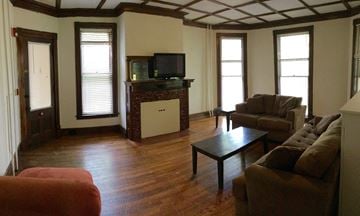 Ithaca apartment for rent - A living room with a brown couch and a black coffee table.