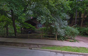 Ithaca apartment for rent - a house in the woods behind a wooden fence