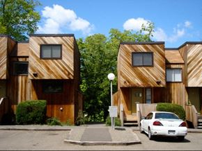 Ithaca apartment for rent - a car parked in front of a row of wooden houses
