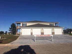 Manitowoc apartment for rent - A building with a sign that says Total Service Development.