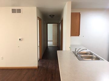Manitowoc apartment for rent - A kitchen with a sink and a hallway.