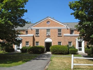 Ithaca apartment for rent - a large brick building with a sidewalk in front of it
