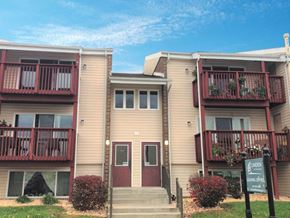 Martinsburg apartment for rent - an apartment building with red balconies and a sign in front
