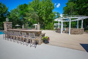 Westlake apartment for rent - a large patio with chairs and a bar and a pool