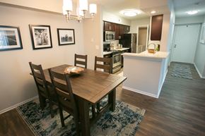 Westlake apartment for rent - a dining room and kitchen with a wooden table and chairs
