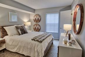 Westlake apartment for rent - a bedroom with a bed and a dresser and a window