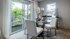 Stow apartment for rent - a dining room with a glass table and white chairs