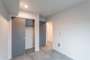 Seattle apartment for rent - a bedroom with a closet and a door to a laundry room