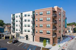 Whiting apartment for rent - an apartment building in a parking lot with a blue sky