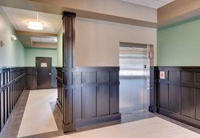 Whiting apartment for rent - a hallway with wood paneling and a door