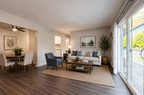 Cincinnati apartment for rent - A living room with a sofa, chairs, and a dining table.