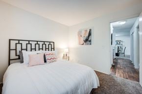 Cincinnati apartment for rent - A bedroom with a large bed and a painting on the wall.
