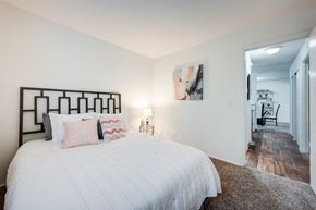 Cincinnati apartment for rent - A bedroom with a large bed and a painting on the wall.