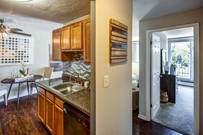 Oakwood Village apartment for rent - A kitchen with wooden cabinets and a dining table.