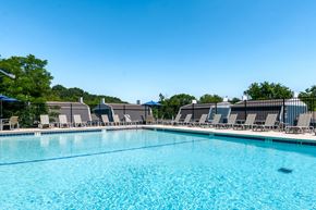 Pittsburgh townhouse for rent - our resort style swimming pool is surrounded by lounge chairs and umbrellas