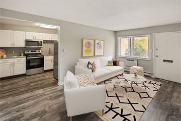 Fort Wayne townhouse for rent - a living room with white furniture and a kitchen