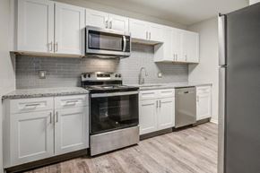Fort Wayne townhouse for rent - White Kitchen with Stainless-Steel Appliances and Granite Countertops