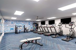 Pittsburgh apartment for rent - a rendering of a gym with cardio machines and weights